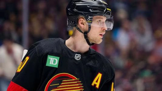 Elias Pettersson wearing the matte black Vancouver Canucks jersey Elias Pettersson wearing the matte black Vancouver Canucks jersey