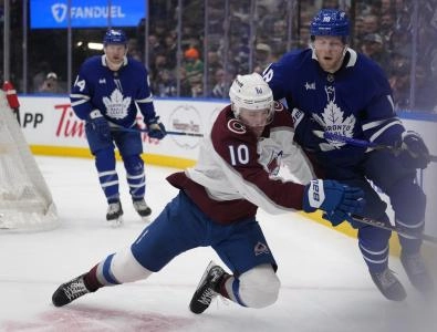 Mar 19, 2025; Toronto, Ontario, CAN; Colorado Avalanche forward Charlie Coyle (10) goes to check Toronto Maple Leafs forward Steven Lorentz (18) along the boards during the second period at Scotiabank Arena Mar 19, 2025; Toronto, Ontario, CAN; Colorado Avalanche forward Charlie Coyle (10) goes to check Toronto Maple Leafs forward Steven Lorentz (18) along the boards during the second period at Scotiabank Arena