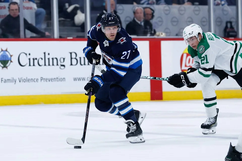 Winnipeg Jets forward Nikolaj Ehlers (27) skates away from Dallas Stars forward Jason Robertson (21) during the second period at Canada Life Centre. Terrence Lee-Imagn Images