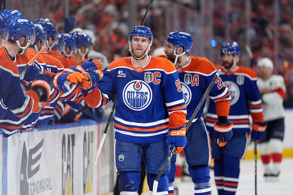 Edmonton Oilers centre Connor McDavid, front right, celebrates after his goal with teammates during the third period in Game 5 of the NHL hockey Stanley Cup Final against the Florida Panthers in Edmonton, Alberta, Saturday, June 14, 2025. (Darryl Dyck/The Canadian Press via AP)