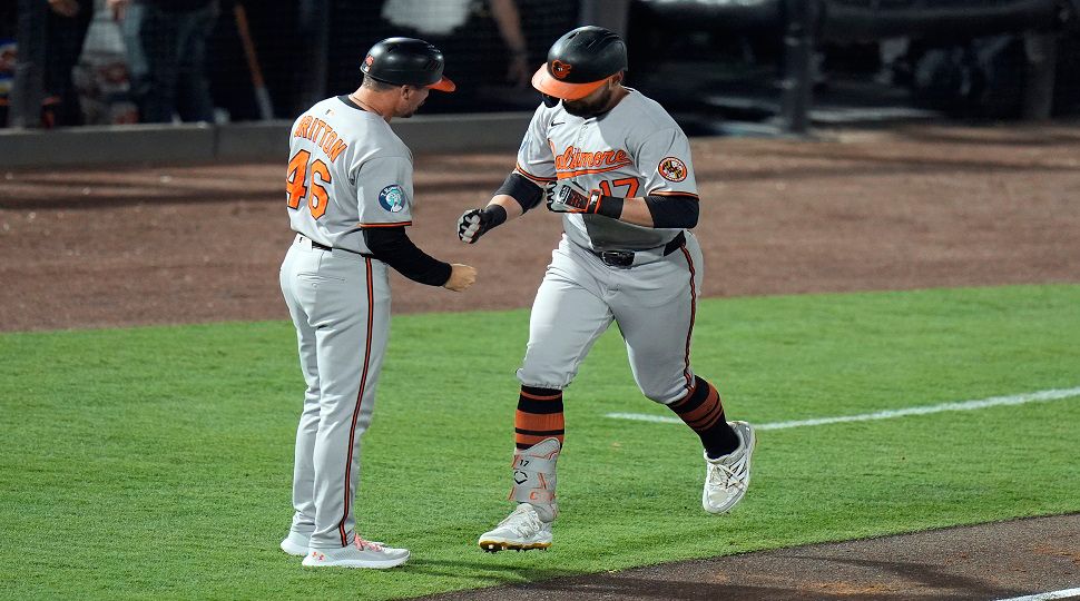 Baltimore Orioles' Colton Cowser (17) celebrates with interim third base/infield coach Buck Britton (46) after his solo home run off Tampa Bay Rays pitcher Zack Littell during the fifth inning of a baseball game Tuesday, June 17, 2025, in Tampa, Fla. (AP Photo/Chris O'Meara)