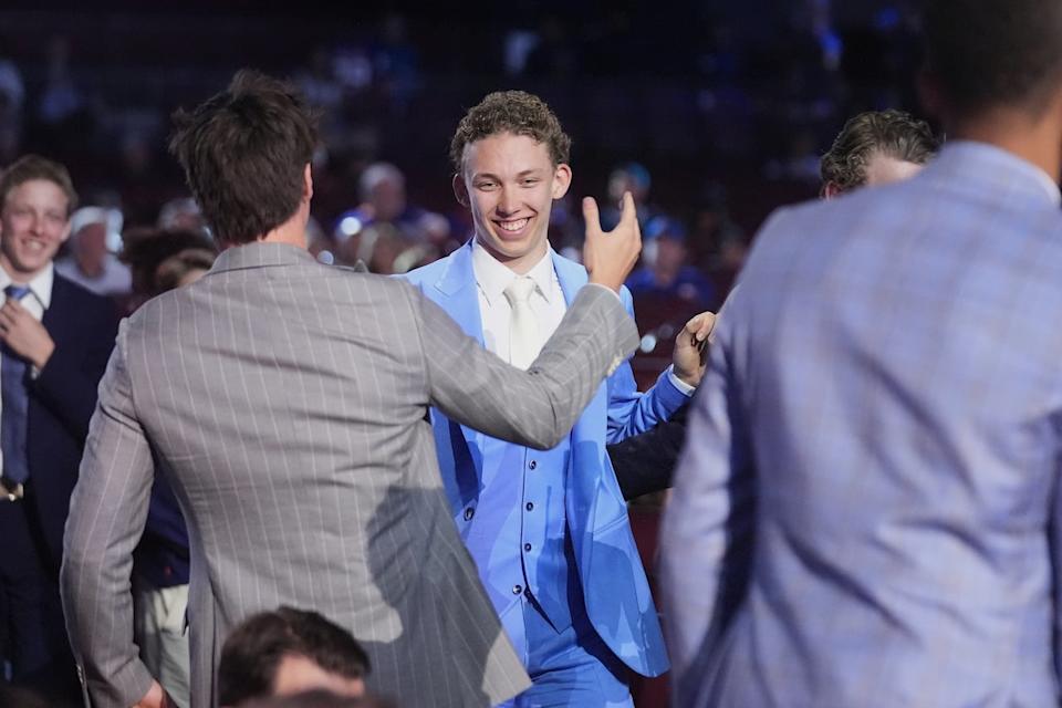 Sascha Boumedienne, middle, is congratulated after being drafted by the Winnipeg Jets during the NHL draft Friday night.