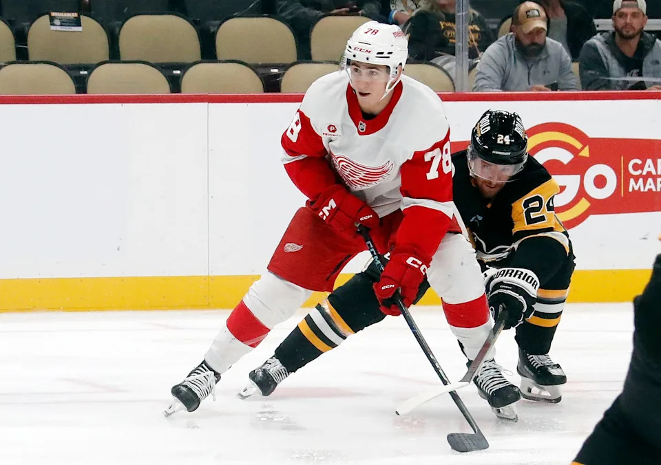 Detroit Red Wings center Amadeus Lombardi (78) skates in on goal against Pittsburgh Penguins defenseman Matt Grzelcyk (24) during the second period at PPG Paints Arena in Pittsburgh on Tuesday, Oct. 1, 2024.