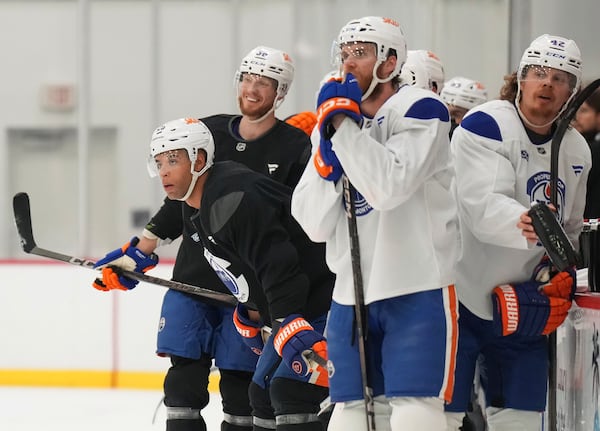 Edmonton Oilers defenceman Darnell Nurse, left, looks up ice during practice at the NHL Stanley Cup Finals in Fort Lauderdale, Fla., Tuesday, June 10, 2025.(Nathan Denette/The Canadian Press via AP)