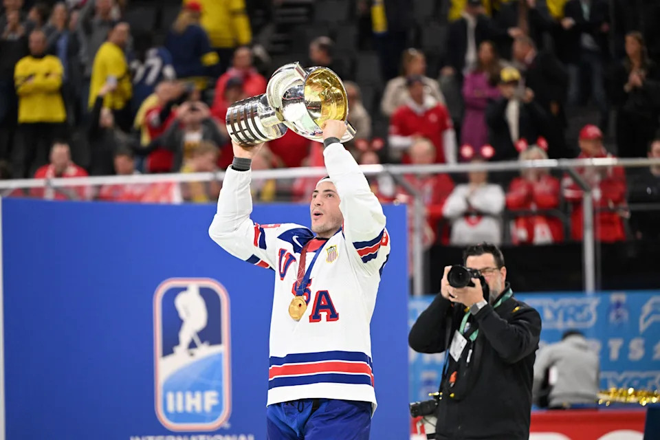 US defender #08 Zach Werenski raises the throphy after winning gold during the overtime of the IIHF Men's Ice Hockey World Championship final match between Switzerland and USA in Stockholm, on May 25, 2025. (Photo by Jonathan NACKSTRAND / AFP) (Photo by JONATHAN NACKSTRAND/AFP via Getty Images)