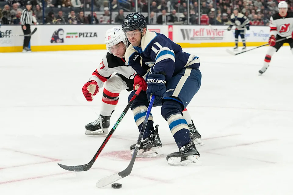 Jan 19, 2024; Columbus, Ohio, USA; Columbus Blue Jackets center Adam Fantilli (11) skates around New Jersey Devils defenseman Simon Nemec (17) during the first period of the NHL hockey game at Nationwide Arena.