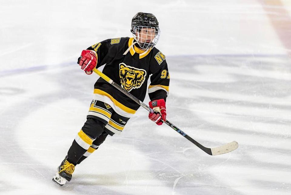 William Gruben or Evander Jerome playing hockey.