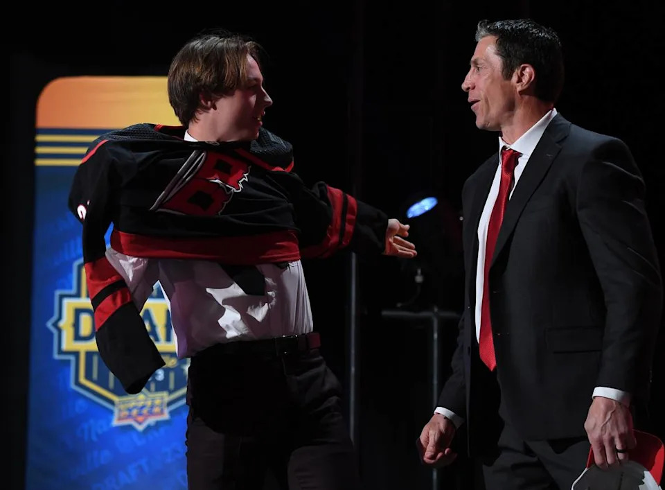 Carolina Hurricanes draft pick Bradly Nadeau talks with head coach Rod BrindAmour after being selected with the thirtieth pick in round one of the 2023 NHL Draft at Bridgestone Arena.