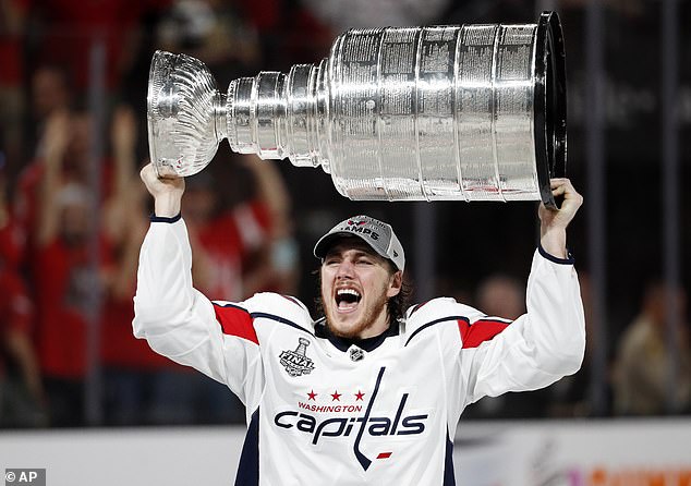 Capitals forward TJ Oshie hoists the Stanley Cup aloft after Washington's win back in 2018