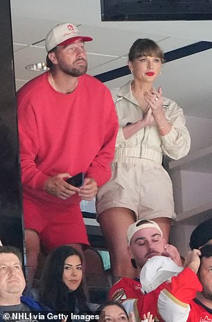 Swift wore a stylish cream white jacket and matching shorts at the game