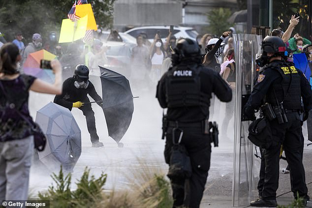 DENVER: Police use chemical agents to disperse protestors blocking a street