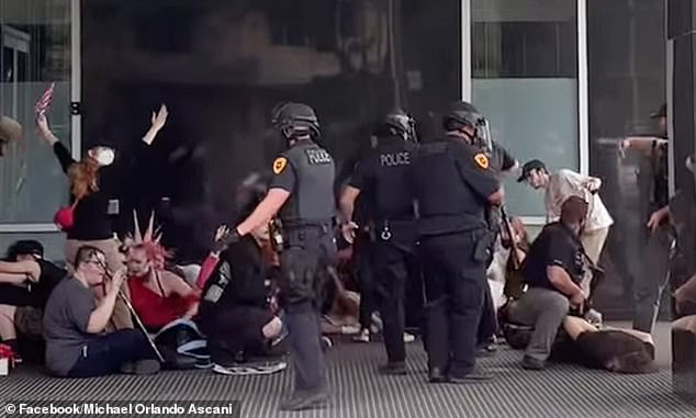 Things quickly turned violent in Salt Lake City Saturday after gunshots rang out while an estimated 10,000 people gathered to protest. The suspect (far right) is seen being arrested after several witnesses identified him to police