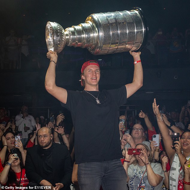 Lundell lifts the Stanley Cup trophy above his head during celebrates at E11EVEN in Miami