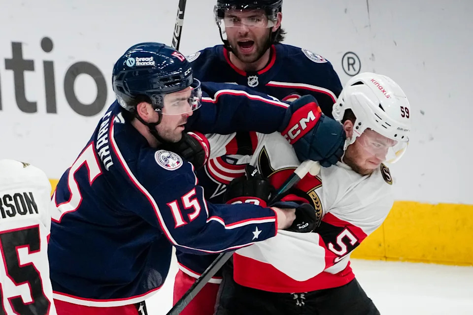 Columbus Blue Jackets defenseman Dante Fabbro (15) hits Ottawa Senators left wing Angus Crookshank (59) during the second period of the NHL hockey game at Nationwide Arena in Columbus on April 8, 2025.