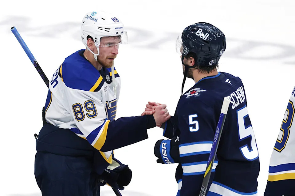 Blues left wing Pavel Buchnevich (89) and Jets defenseman Luke Schenn (5) shake hands.James Carey Lauder-Imagn Images