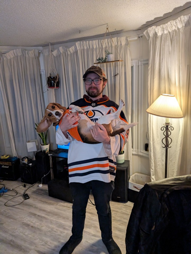 Adam Gordon and dog Rosie Beans in their Oilers jerseys.