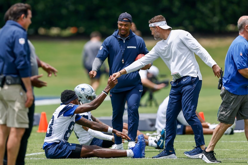 Dallas Cowboys wide receiver Jalen Brooks (83) shakes hands with head coach Brian...