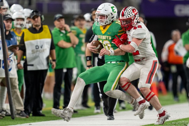 Edina quarterback Mason West gets a first down and draws a roughing call on Centennial's Caden Coppersmith during the Minnesota Class 6A championship game Nov. 24, 2023, at U.S. Bank Stadium in Minneapolis. (Matt Blewett/Special to the St. Paul Pioneer Press)