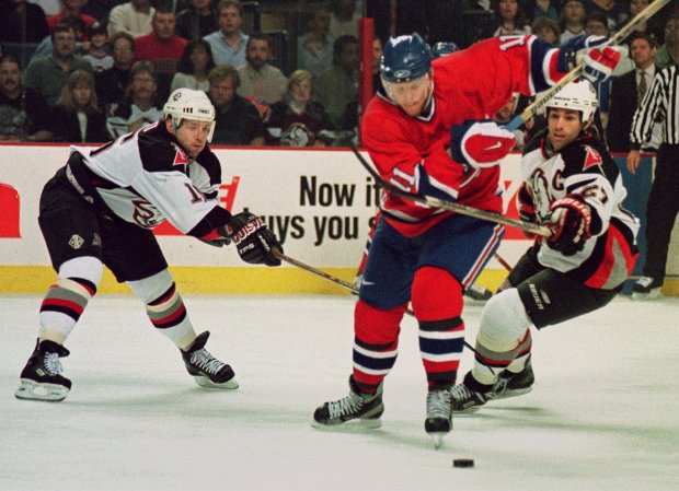 Buffalo Sabres forwards Dixon Ward, left, and Michael Peca (27) tie up Montreal Canadiens center Saku Koivu (11) as he chases the puck in the first period Friday, May 8, 1998, at Marine Midland Arena in Buffalo, N.Y. (AP Photo/Don Heupel) ORG XMIT: BFA105