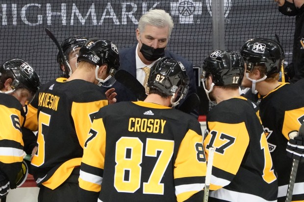 Penguins assistant coach Mike Vellucci, center, talks with players during a timeout against the Capitals on Feb. 14, 2021, in Pittsburgh. (Keith Srakocic/AP)