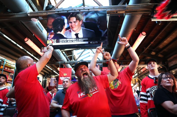 Fans, including Doug Michaels, react after the Chicago Blackhawks selected...