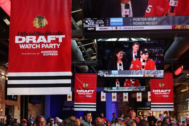An image of Anton Frondell (cq) and his parents being interviewed after Frondell was selected by the Chicago Blackhawks with the third overall pick the 2025 NHL Draft is cast on a screen at the Blackhawks official draft party at Recess on W. Kinzie St. in Chicago on Friday, June 27, 2025. (Chris Sweda/Chicago Tribune)