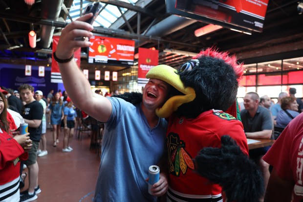 Cullen Foley takes a selfie with Chicago Blackhawks mascot Tommy...