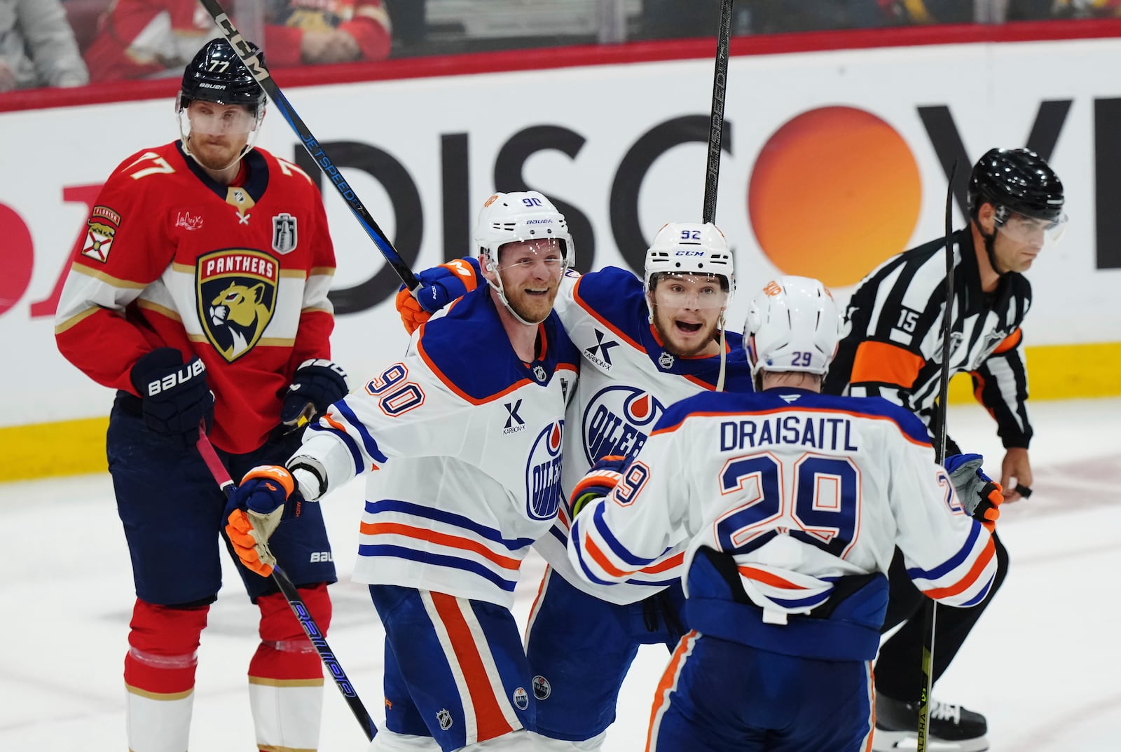 Edmonton Oilers' Vasily Podkolzin (92) celebrates after his goal with Corey Perry (90) and Leon Draisaitl (29) as Florida Panthers' Niko Mikkola (77) looks on during the second period in Game 4 of the NHL hockey Stanley Cup Final in Sunrise, Fla., Thursday, June 12, 2025. (Nathan Denette/The Canadian Press via AP)