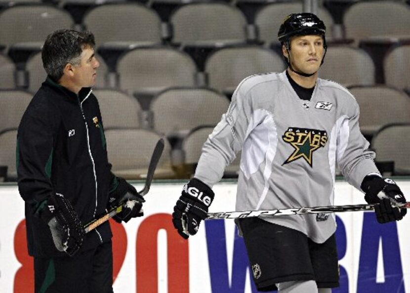 Dallas Stars head coach Dave Tippett (left) talks with Sean Avery during morning practice...