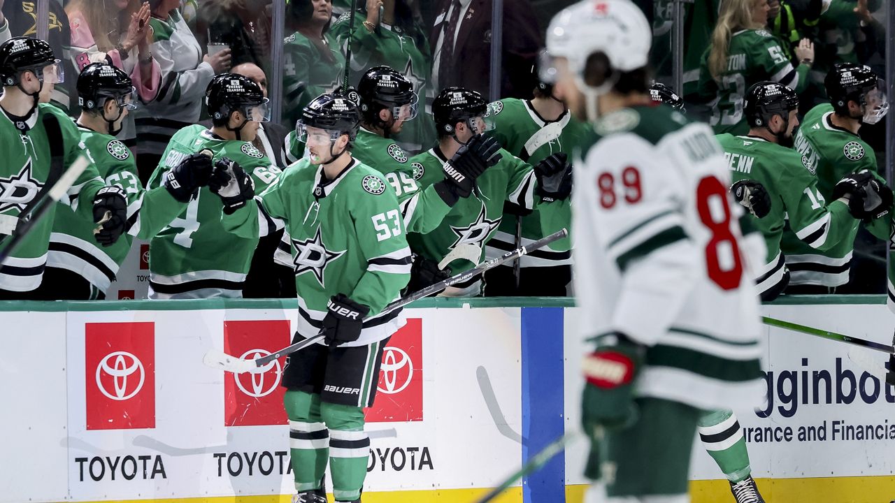 Dallas Stars center Wyatt Johnston (53) celebrates with his team after scoring in the second period of an NHL hockey game against the Minnesota Wild in Dallas, Monday, March 24, 2025. (AP Photo/Gareth Patterson)