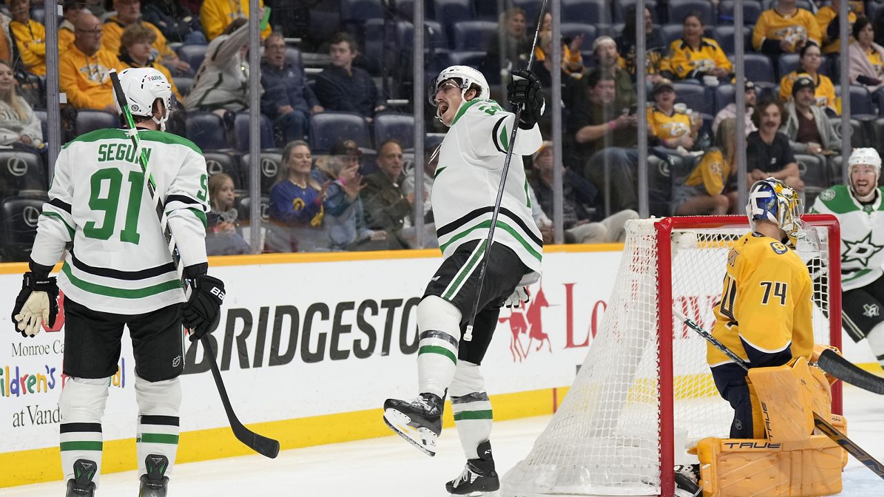 Dallas Stars left wing Mason Marchment, center, celebrates his goal with center Tyler Seguin (91) during the first period of an NHL hockey game against the Nashville Predators, Wednesday, April 16, 2025, in Nashville, Tenn. (AP Photo/George Walker IV)