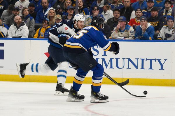 St. Louis Blues defenseman Colton Parayko (55) attempts to block a shot by Winnipeg Jets defenseman Dylan Samberg, left, during the first period in Game 6 of an NHL hockey first-round playoff series Friday, May 2, 2025, in St. Louis. (AP Photo/Jeff Le)