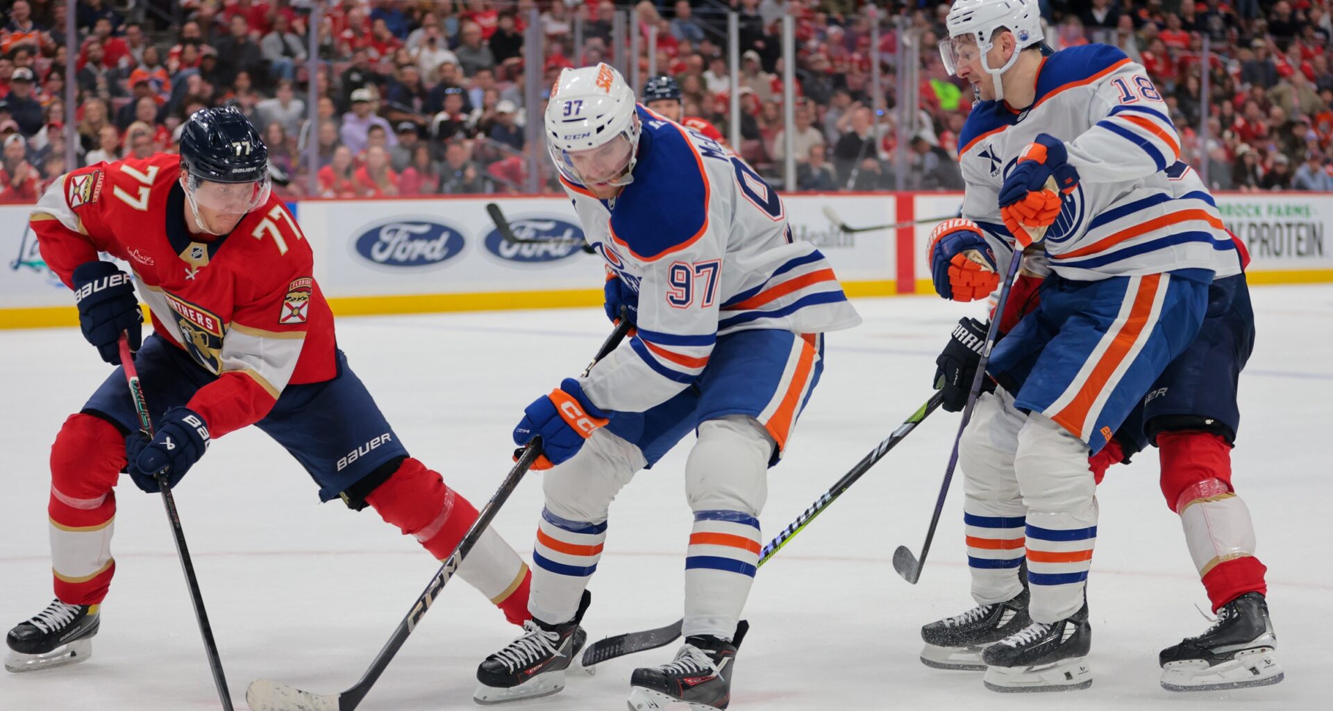 Edmonton Oilers center Connor McDavid (97) moves the puck as Florida Panthers defenseman Niko Mikkola (77) defends during the third period at Amerant Bank Arena.
