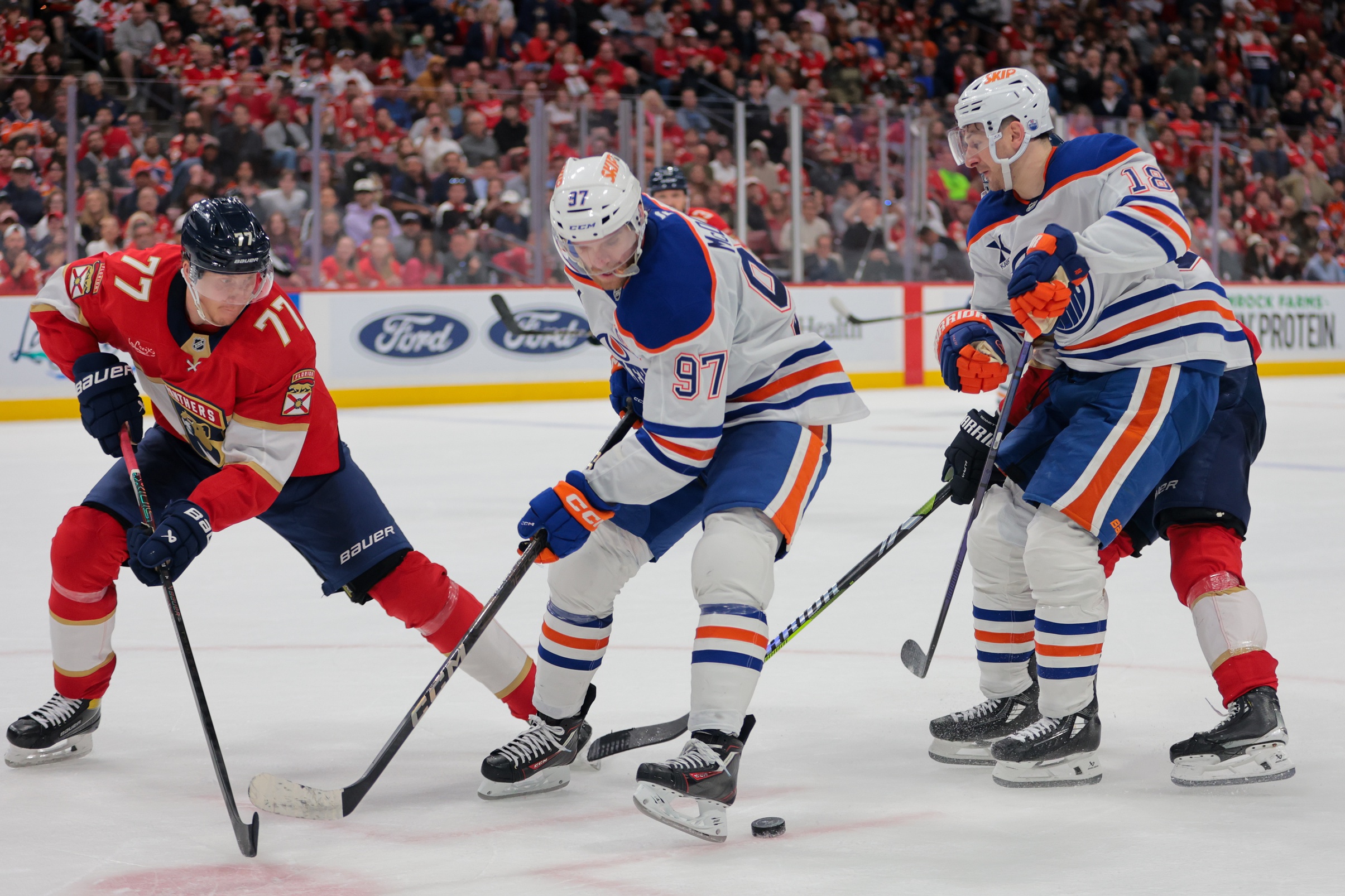 Edmonton Oilers center Connor McDavid (97) moves the puck as Florida Panthers defenseman Niko Mikkola (77) defends during the third period at Amerant Bank Arena.