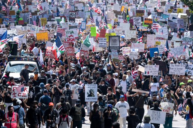 Thousands of No Kings protesters marched against the policies of...
