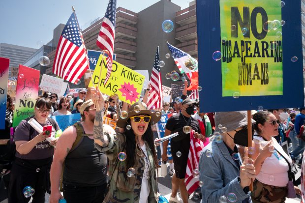 Thousands of No Kings protesters marched against the policies of...