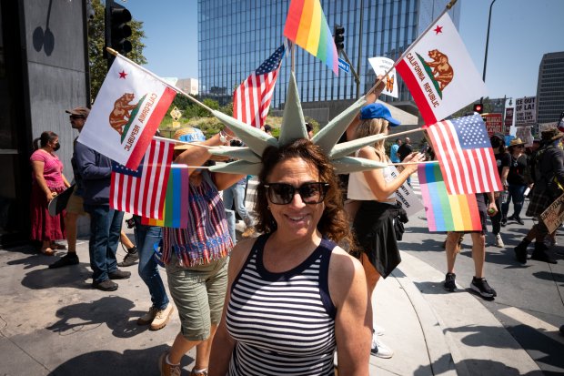 Thousands of No Kings protesters marched against the policies of...