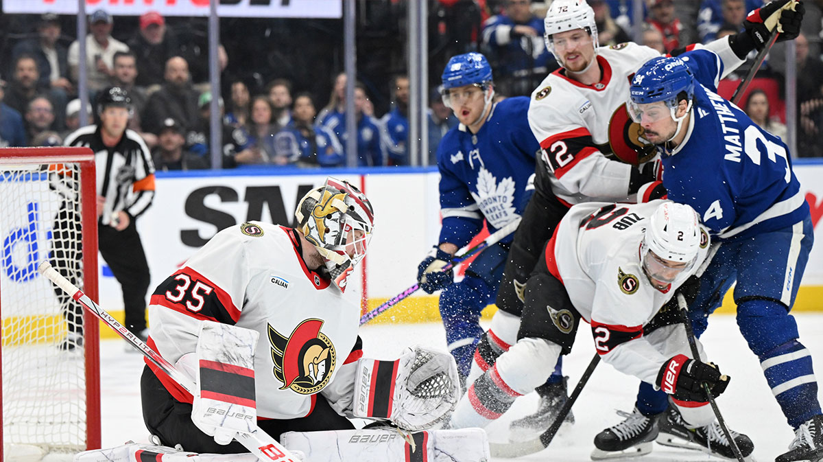 Ottawa Senators goalie Linus Ullmark (35) makes a save as defensemen Artem Zub (2) and Thomas Chabot (72) hold back Toronto Maple Leafs forward Auston Matthews (34) in the third period at Scotiabank Arena