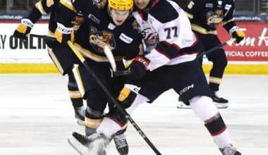 Erie Otters forward Dylan Edwards, leftt, competes against Saginaw Spirit forward Michael Misa during an Ontario Hockey League playoff game at Erie Insurance Arena in Erie on April 1, 2025.