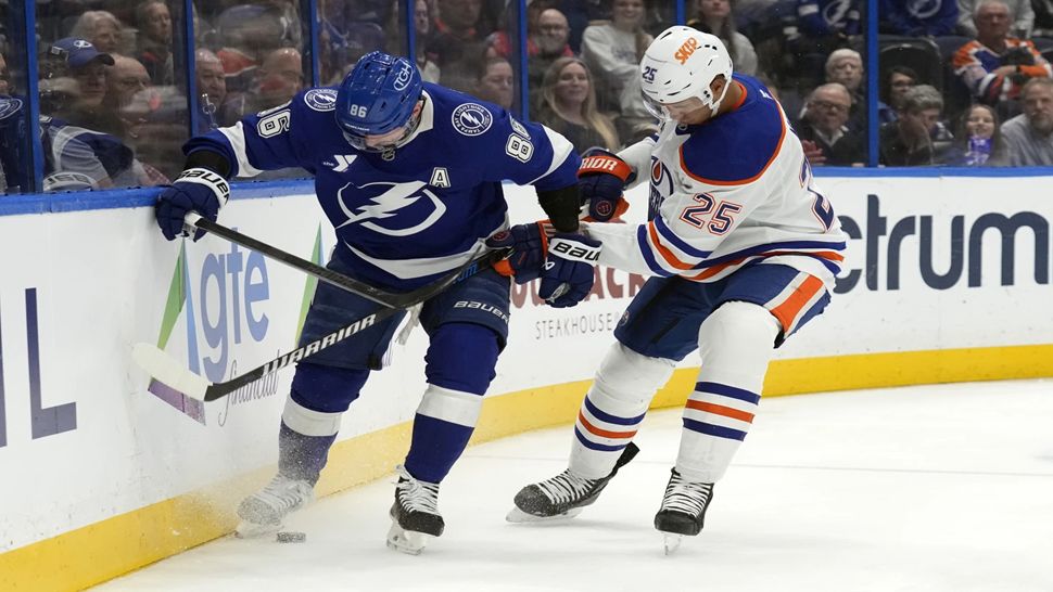 Tampa Bay right wing Nikita Kucherov and Edmonton Oilers defenseman Darnell Nurse (25) battle for the puck during the second period on Tuesday night.
