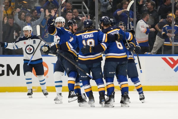 St. Louis Blues defenseman Philip Broberg (6) is congratulated by teammates after scoring a goal against the Winnipeg Jets during the first period in Game 6 of an NHL hockey first-round playoff series Friday, May 2, 2025, in St. Louis. (AP Photo/Jeff Le)
