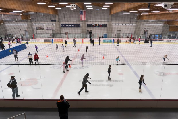 People ice skate at Paul Hruby Ice Arena in Ridgeland Common Recreation Center in Oak Park in Jan., 2022. The arena's namesake, Coach Paul Hruby, has been associated with hockey in Oak Park for over 60 years. (Youngrae Kim/Chicago Tribune)