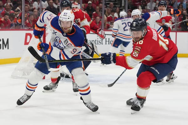 Florida Panthers center Aleksander Barkov (16) defends Edmonton Oilers center Connor McDavid (97) during the first period of Game 3 of the NHL Stanley Cup final Monday, June 9, 2025, in Sunrise, Fla. (AP Photo/Lynne Sladky)