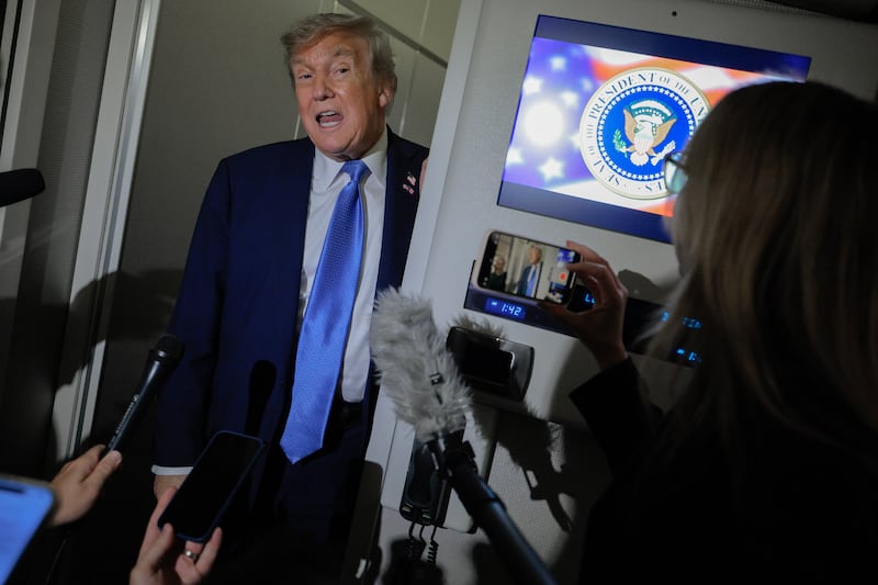 President Donald Trump talks to reporters on board Air Force One after leaving early from the G7 summit on June 16, 2025 in Calgary, Alberta where he was asked about whether he would call Minnesota Governor Tim Walz after the assassination of a state lawmaker and her husband and shooting of a state senator and his wife.