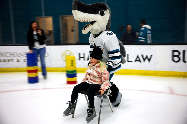 San Jose Sharks mascot SJ Sharkie pushes Ella Pallari, 7, from Livermore, as her mom Noelle watches on during the LKT1D Fund (Luke Kunin Type 1 Diabetes) Skating Party at Sharks Ice in San Jose, Calif., on Sunday, Jan. 26, 2025. (Nhat V. Meyer/Bay Area News Group)