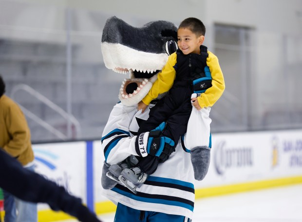 Juan Cruz, 5, from San Jose, get a ride from San Jose Sharks mascot SJ Sharkie during the LKT1D Fund (Luke Kunin Type 1 Diabetes) Skating Party at Sharks Ice in San Jose, Calif., on Sunday, Jan. 26, 2025. (Nhat V. Meyer/Bay Area News Group)