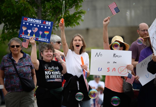 Pat Spindler, of Tinley Park, cheers and blows bubbles during the south suburbs No Kings protest along La Grange Road in Orland Park June 14, 2025. (Andrew Burke-Stevenson/for the Daily Southtown)