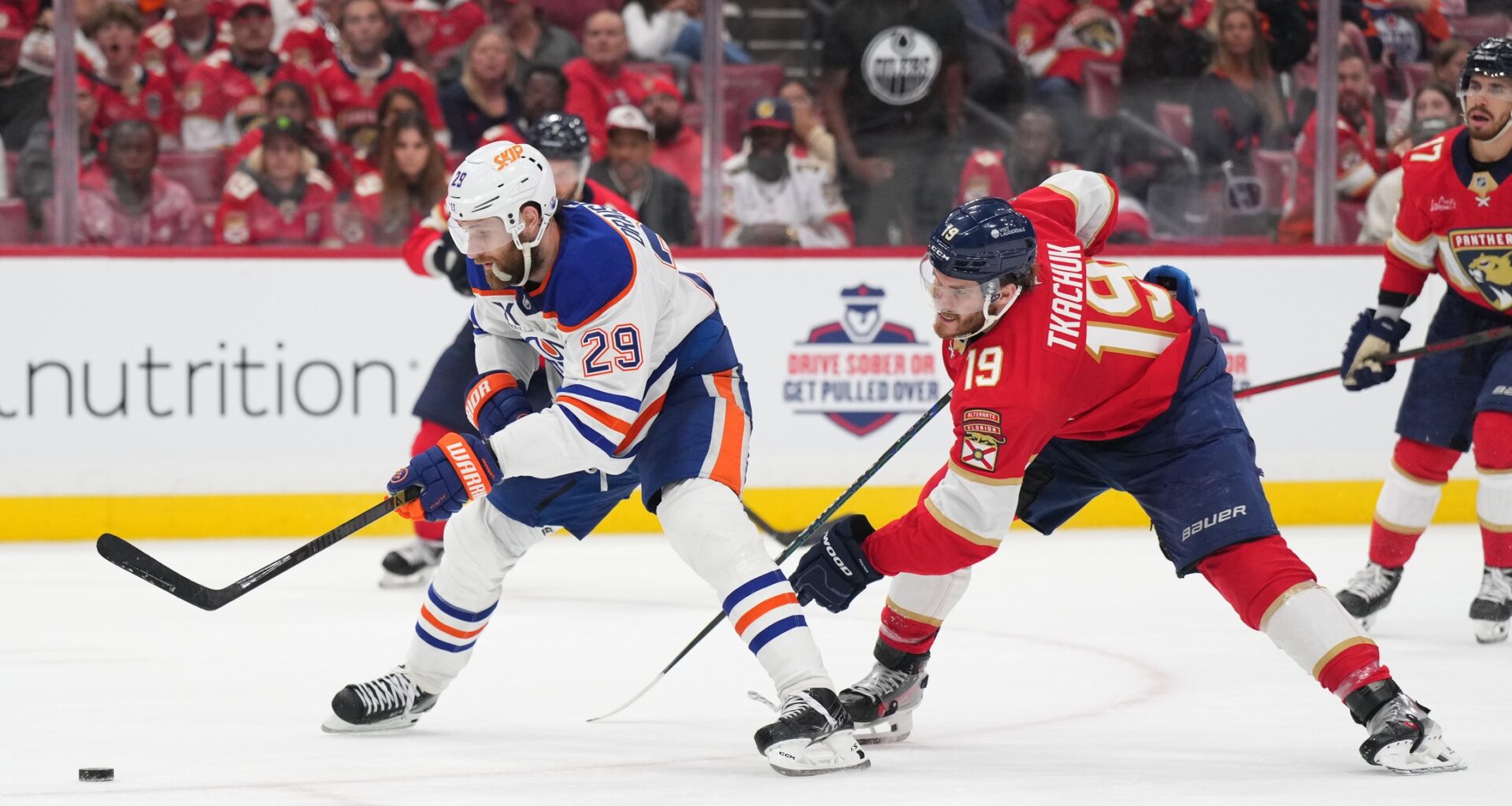 Edmonton Oilers center Leon Draisaitl (29) battles for the puck against Florida Panthers forward Matthew Tkachuk (19) during the third period in game four of the 2025 Stanley Cup Final at Amerant Bank Arena.