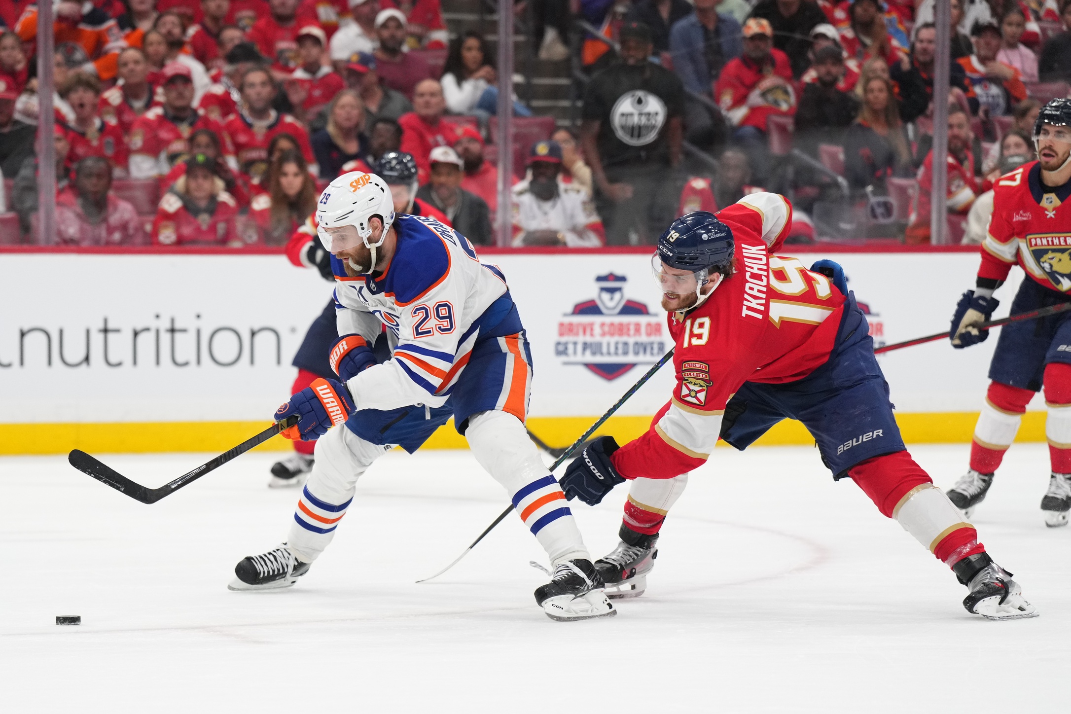 Edmonton Oilers center Leon Draisaitl (29) battles for the puck against Florida Panthers forward Matthew Tkachuk (19) during the third period in game four of the 2025 Stanley Cup Final at Amerant Bank Arena.
