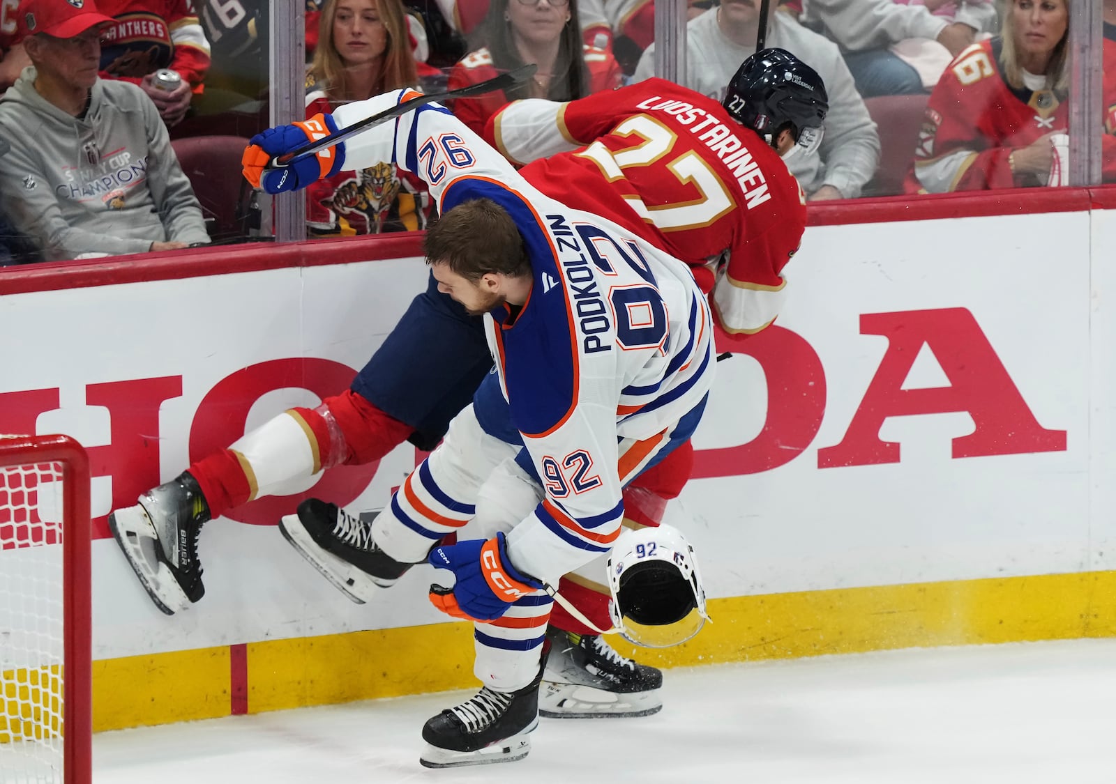 Florida Panthers' Eetu Luostarinen (27) hits Edmonton Oilers' Vasily Podkolzin (92) during the second period in Game 4 of the NHL hockey Stanley Cup Final in Sunrise, Fla., Thursday, June 12, 2025. (Nathan Denette/The Canadian Press via AP)